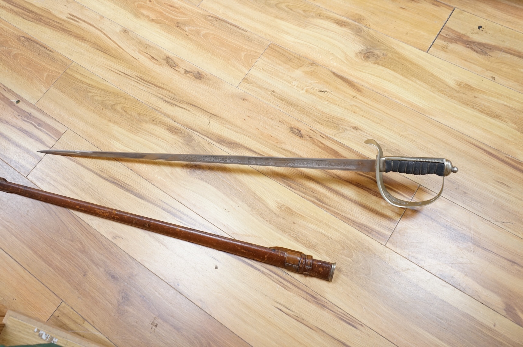 A George V 1897 pattern infantry officer’s sword, with regulation blade etched with the union flowers, Royal Arms and owners name; J.W. Reynolds, Dorrington, Lincoln, regulation nickel guard stamped ‘WH&S’ in minuscules,
